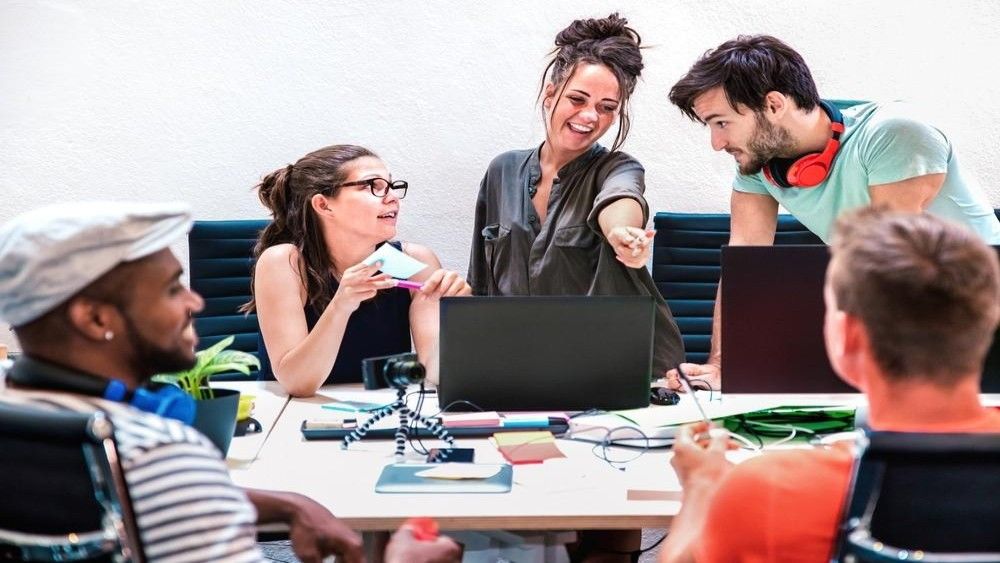 Diverse marketing team discussing ideas during a creative influencer marketing strategy meeting in office