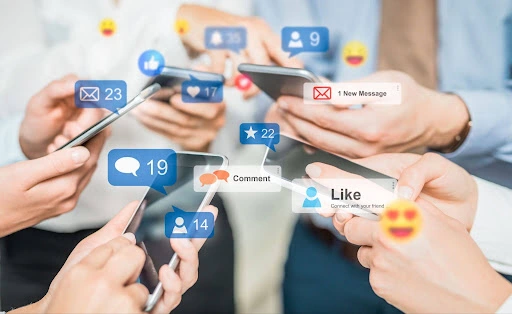 Group of people using smartphones with social media notification icons for likes, comments, and messages, representing social media campaign planning